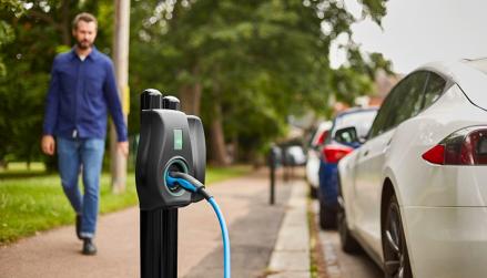 Man walks down path next to Connected Kerb on-street charge point