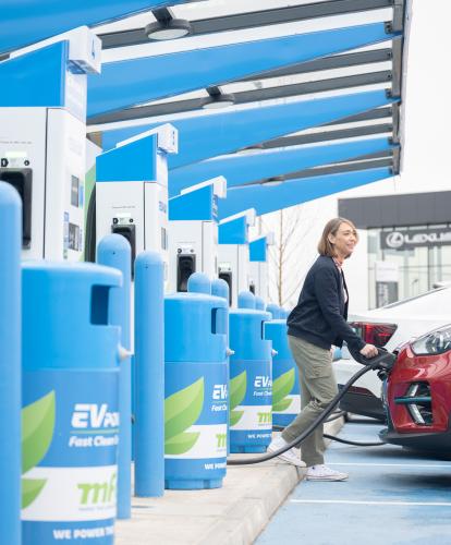 Couple charges their EV at MFG charger hub