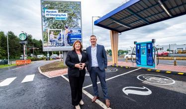 Cabinet Secretary for Transport, Fiona Hyslop and Lead Director, EV at SSE Energy Solutions, Simon Cowling pose in front of an EV charging bay at the Myrekirk Roundabout in Dundee.